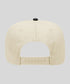 Beige cap with a black button on a light gray background